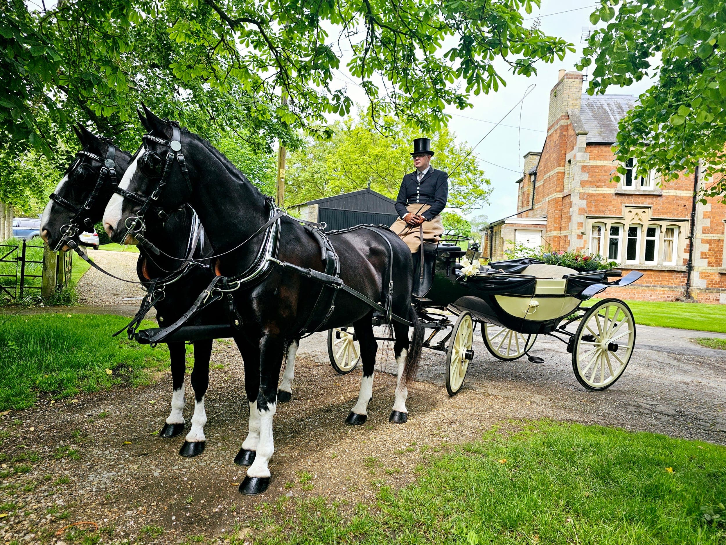 Black horses with ivory Landau carriage at a Lincolnshire manor house wedding